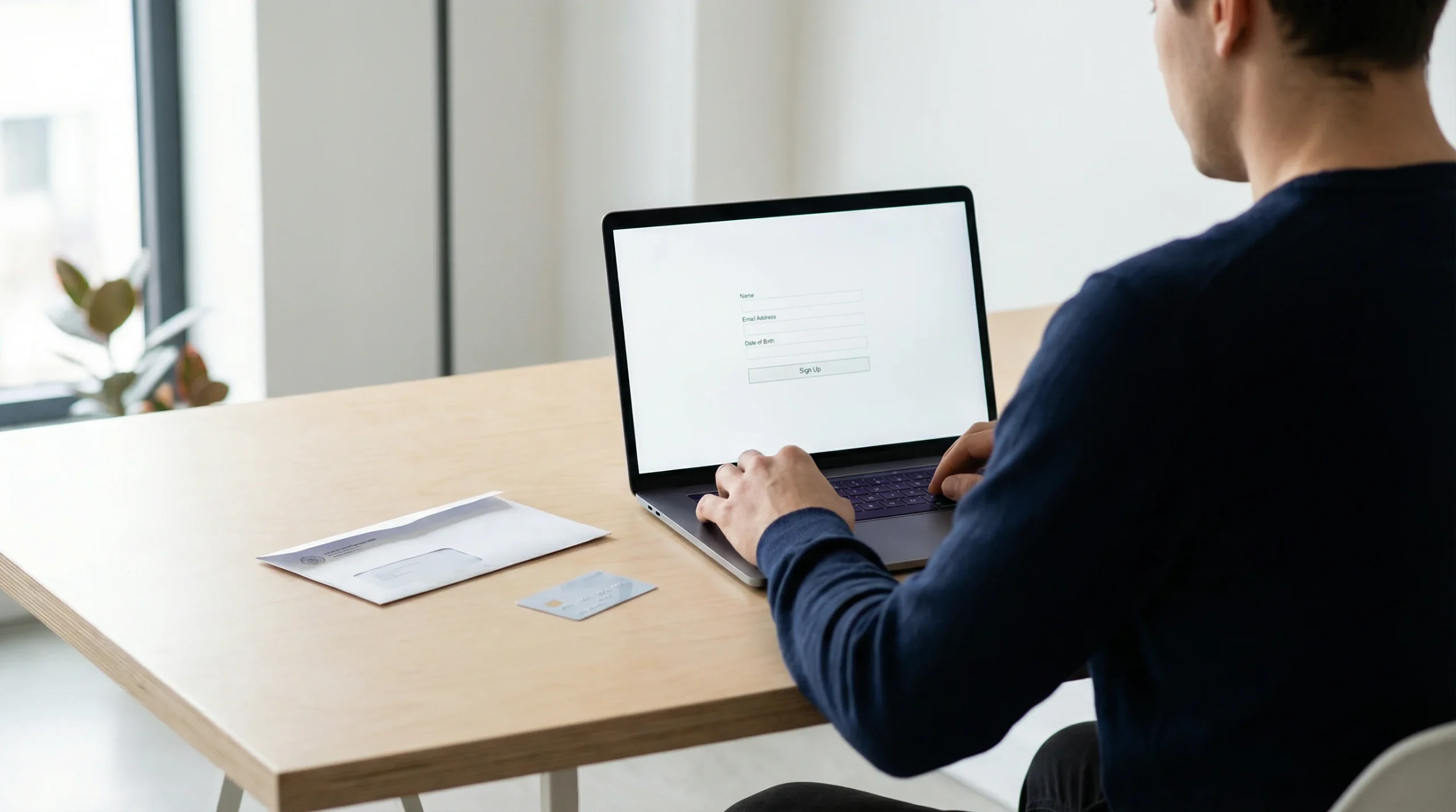 Person completing online casino registration on a laptop with KYC documents on a desk